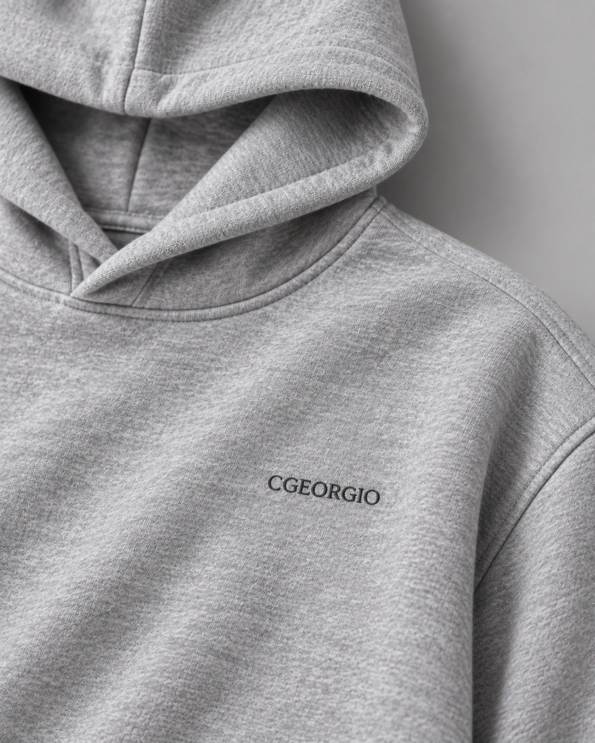 Marl grey hoodie embroidered chest branding and fabric close-up