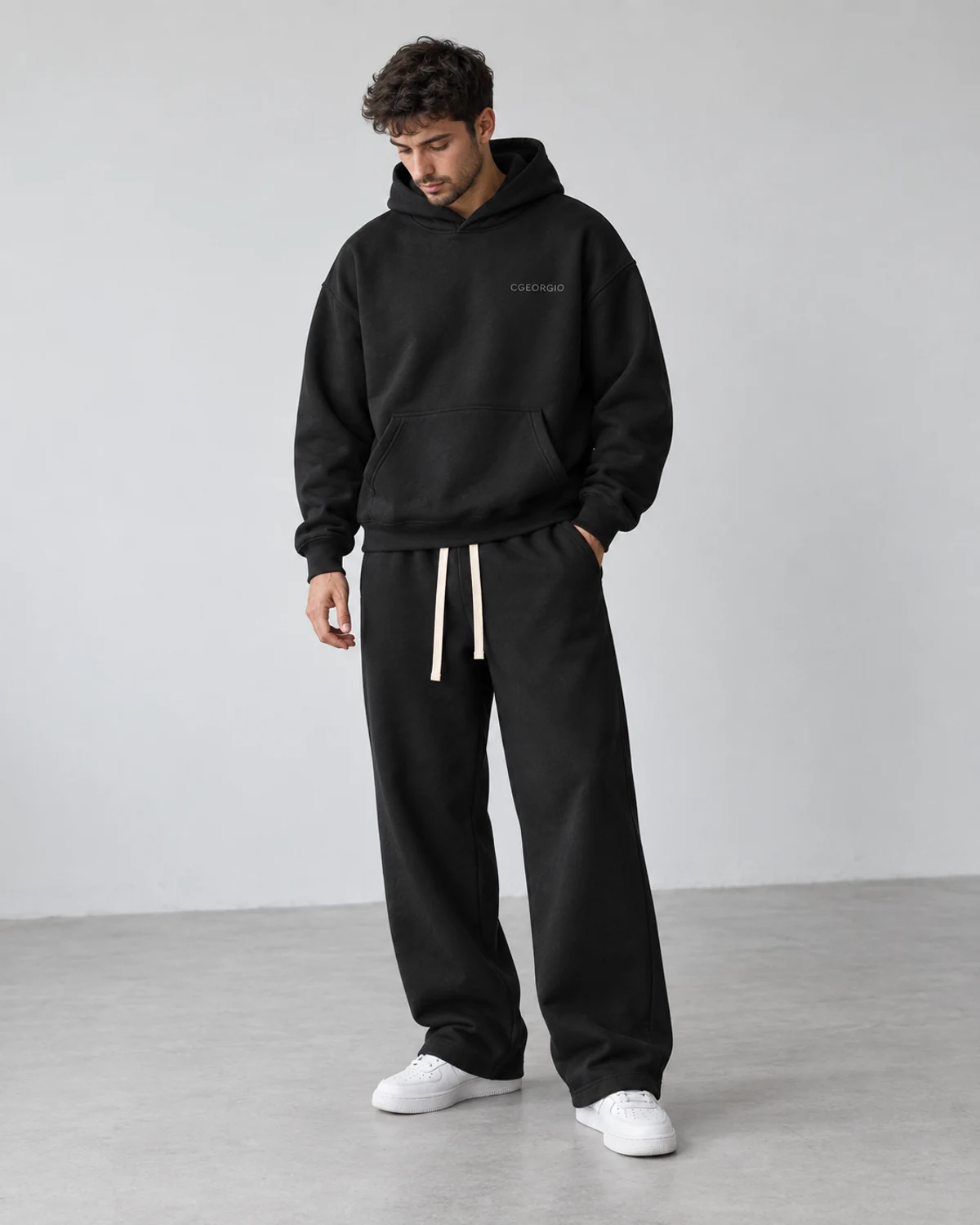 CGEORGIO oversized hoodie and joggers in black, worn as a complete outfit